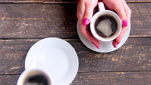 Cups with a coffee in the hands 