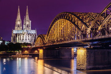 Cologne, Germany. Night View Of Cologne Cathedral And Hohenzollern Bridge