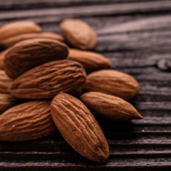 almond essential oil on a wooden background