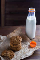 homemade cookies and milk bottle wooden background