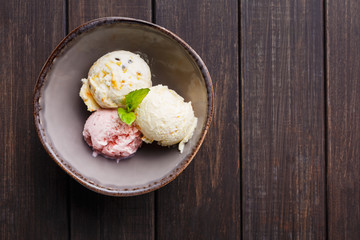 Assorted ice cream scoops in bowl top view