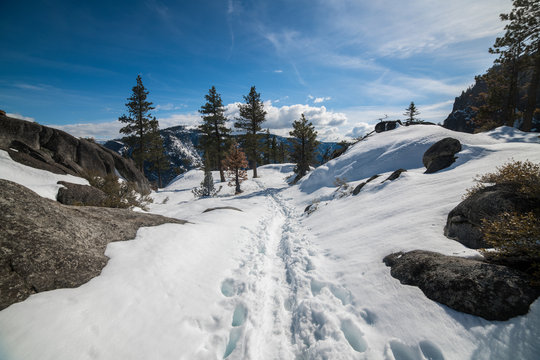 Scenic nature mountain view hiking trail under snow at winter time
