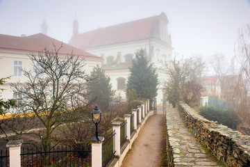 View of the Archangel Michael Church on a foggy winter day. Historical downtown of Znojmo, Czech Republic, South Moravia, Europe