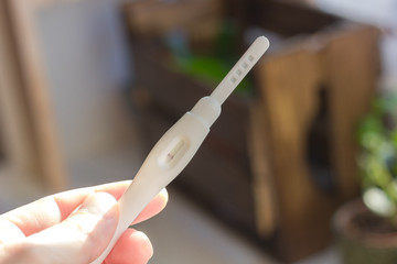 Negative pregnancy test in a human hand.