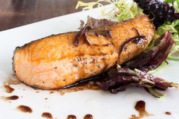 salmon steak with lettuce and sauce
