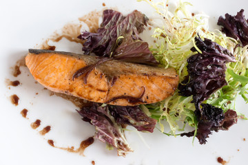 salmon steak with lettuce and sauce