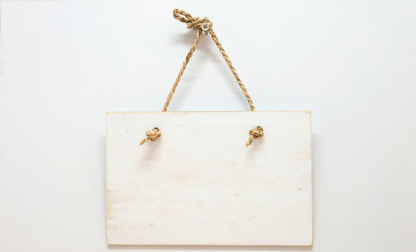 Hang Tags Made Of White Wood With A Rope Hanging On A White Back