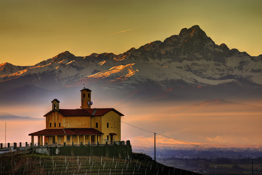 The church of the Partisan Shrine of Bastia Mondov&igrave; with, in the background, the "stone king", the Monviso. 
