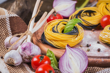 Cherry tomatoes, uncooked spaghetti, red onion and herbs