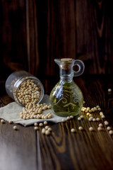 Natural soy bean oil with soybeans near it.