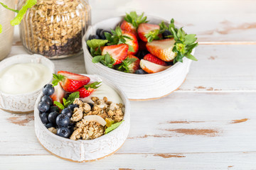 Bowl of natural yogurt with granola and fresh berries
