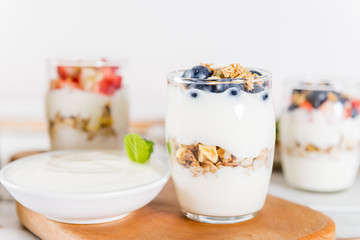 Little Jars with layered dessert from natural yogurt, granola an