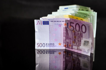 Euros reflected of a black glass surface