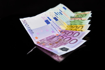 Euros reflected of a black glass surface