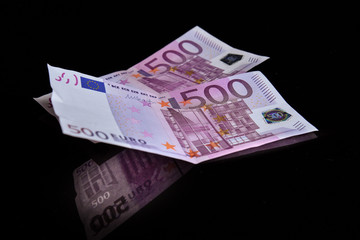 Euros reflected of a black glass surface