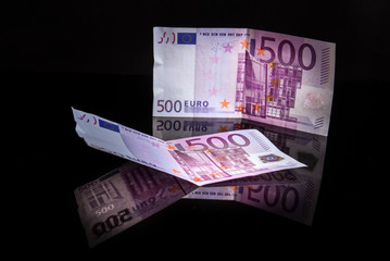 Euros reflected of a black glass surface