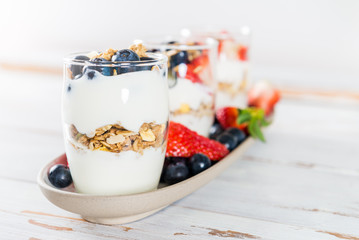 Little Jars with layered dessert from natural yogurt, granola an