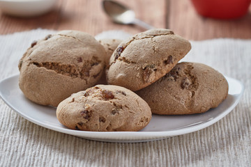 Delicious homemade oatmeal cookies with honey and raisins. Red coffee cup.