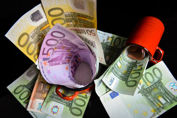 Euro banknotes. Reflection of euros on a black surface. Money saving