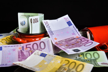 Euro banknotes. Reflection of euros on a black surface. Money saving