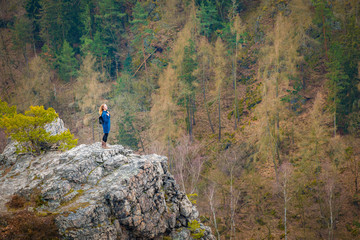 The girl on the rock in mountain, small human in nature