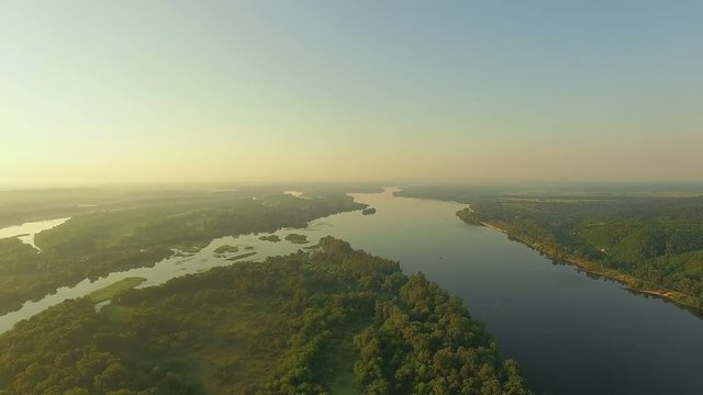 aerial view of river at sunrise 4K, forest and river in morning mist, Very high view of the river forest at sunrise, Aerial view of mystical river at sunrise with fog, sun above the river aerial