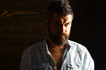 Serious hipster in barbershop, look. Barber and hairdresser salon. Haircut of bearded man, archaism. Fashion and male beauty of graying man. Man with beard and mustache on wooden background.