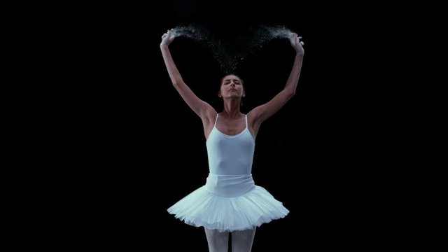 Ballerina performing on black background super slow motion