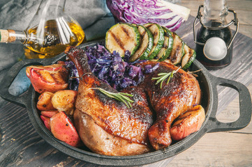 Marinated pieces of duck grilled with red cabbage, onions and apples grilled and served in a rustic style.