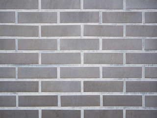 Close-up of gray brick wall texture pattern for background and wallpaper. High-quality macro photography.