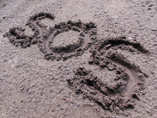 SOS sign written on the ground