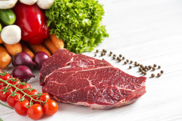Raw meat, different vegetables and fruits on wooden background. Healthy food.