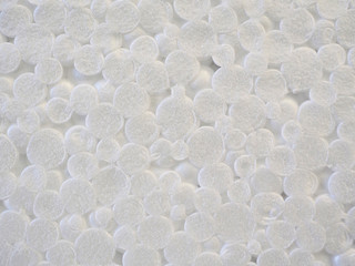 Close-up of white styrofoam with pattern background texture, foam plastic wallpaper. High-quality macro photography.