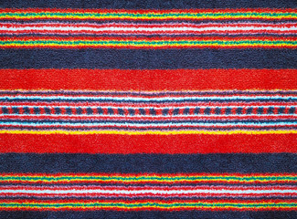 Fototapeta premium Close-up of the multicolor carpet textile texture, background and wallpaper. The texture of multicolor fabric textile upholstery of furniture. High-quality macro photography.