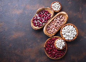 Assortment of various beans in wooden bowls