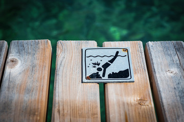 Sign on the pier. Diving is prohibited.