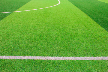 Obraz premium The white Line marking on the artificial green grass soccer field