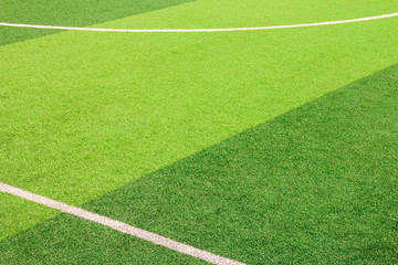 Fototapeta premium The white Line marking on the artificial green grass soccer field