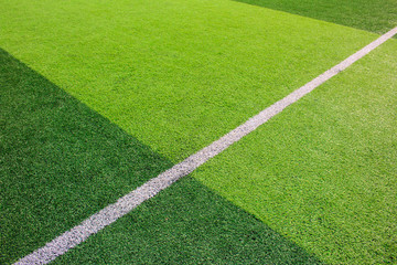 The white Line marking on the artificial green grass soccer field
