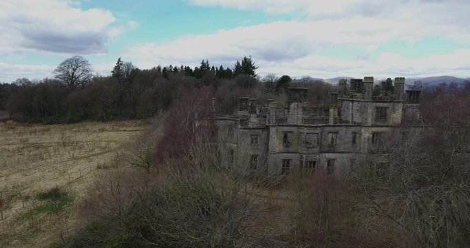Aerial footage of  the spooky Dunmore Park House, a ruined country mansion in Tudor Gothic style near the village of Airth in Central Scotland.