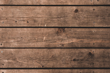 Brown wood background - old worn brown horizontal planks, wooden house wall
