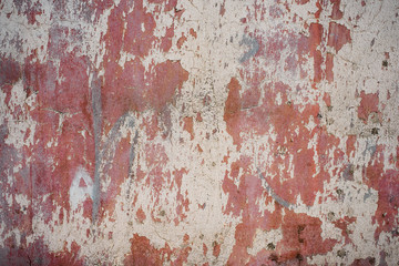 Wall with peeled pink paint - a nice shabby background