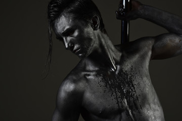 Macho with naked chest, athlete, sportsman performing pole dancing moves.