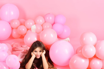 Fototapeta na wymiar Little girl with long hair in pink balloons.