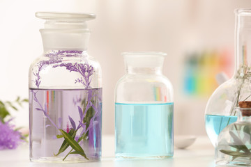 Obraz na płótnie Canvas Bottles with different perfume oils on table