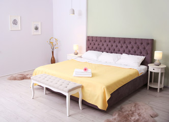 Fototapeta na wymiar Elegant hotel room interior with comfortable bed