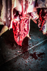 half dead bloody pigs hanging in a slaughterhouse after killed from a butcher
