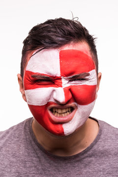 Face portrait of happy fan support Croatia national team with painted face isolated on dark background