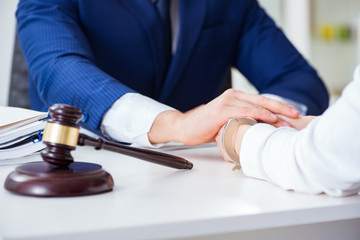 Lawyer talking to his client in office