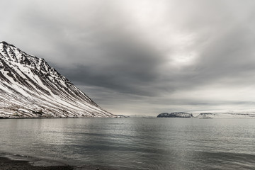 Fjords covered in snow and ocean seashore